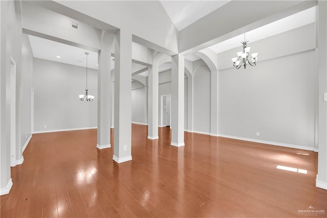 interior space with wood-type flooring and an inviting chandelier