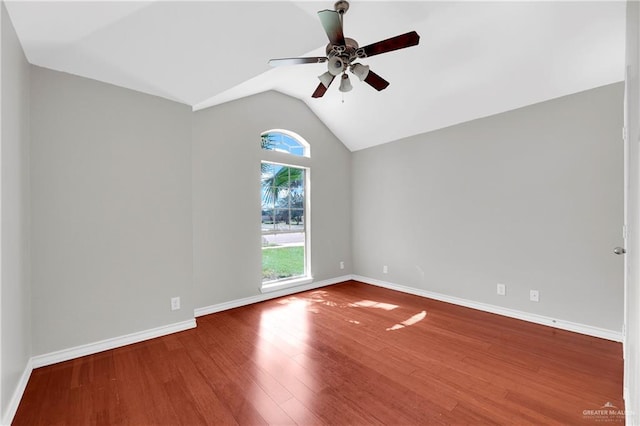 spare room featuring wood-type flooring, vaulted ceiling, and ceiling fan