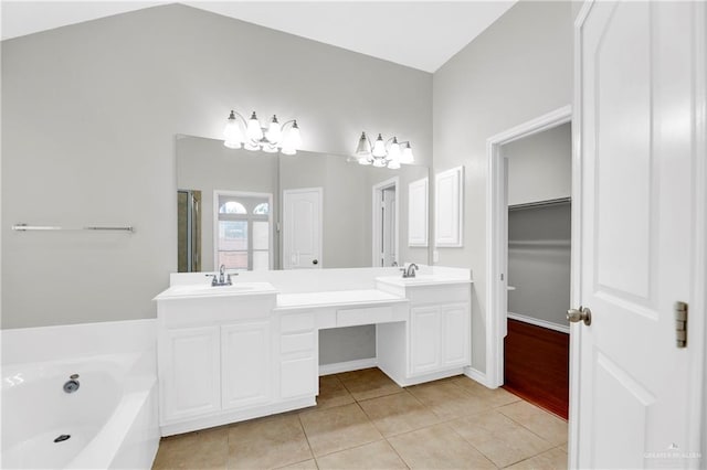 bathroom featuring vanity, separate shower and tub, vaulted ceiling, an inviting chandelier, and tile patterned flooring