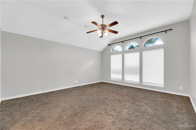 unfurnished room with ceiling fan, lofted ceiling, and dark colored carpet