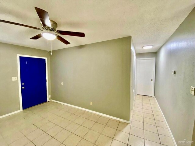506 N Mccoll Rd, Edinburg, TX 78541 - spare room featuring a textured ceiling, ceiling fan, baseboards, and light tile patterned flooring