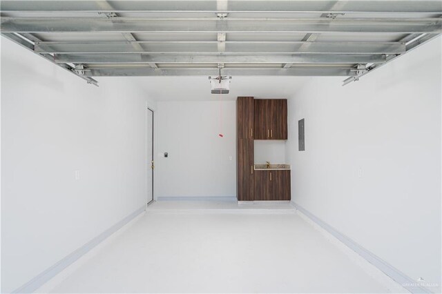 garage featuring electric panel and a garage door opener