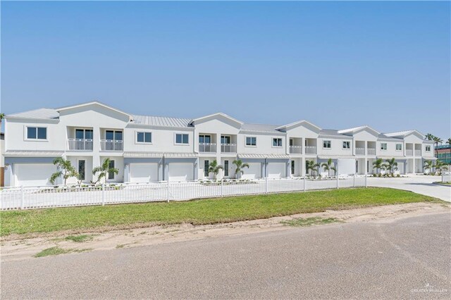 townhome / multi-family property featuring a garage and a balcony