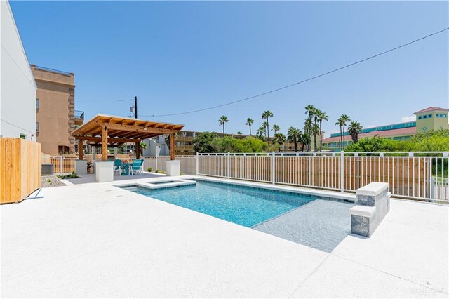 view of pool with a patio area and an in ground hot tub