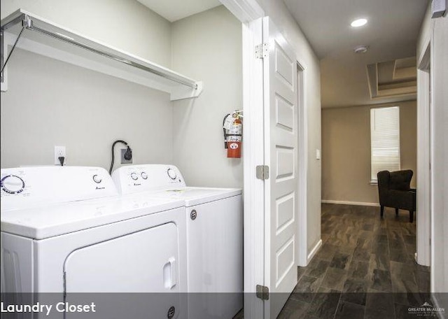 laundry area with washer and dryer and dark wood-type flooring