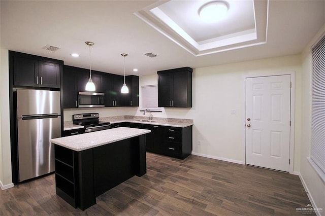 kitchen featuring sink, hanging light fixtures, dark hardwood / wood-style floors, a kitchen island, and stainless steel appliances