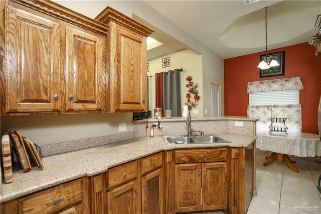 1110 E 8th St N, San Juan, TX 78589 - kitchen featuring a sink, brown cabinetry, and light tile patterned floors