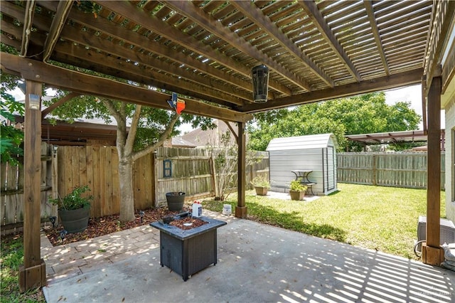 1110 E 8th St N, San Juan, TX 78589 - view of patio featuring a storage unit, a pergola, an outdoor fire pit, and an outbuilding