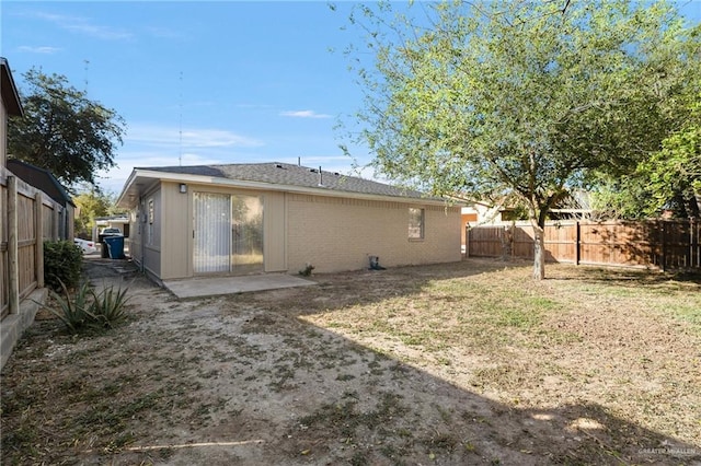 back of property with a patio