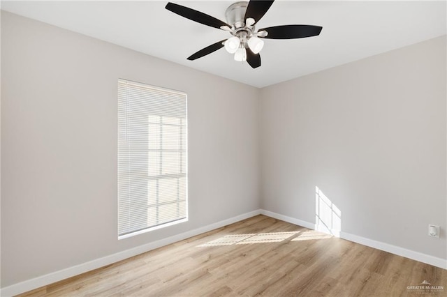 spare room featuring plenty of natural light, ceiling fan, and light hardwood / wood-style flooring