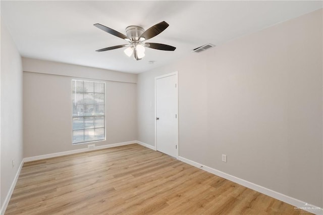 empty room with ceiling fan and light hardwood / wood-style floors