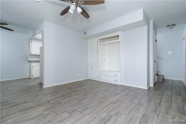 unfurnished bedroom featuring ensuite bathroom, ceiling fan, and light wood-type flooring