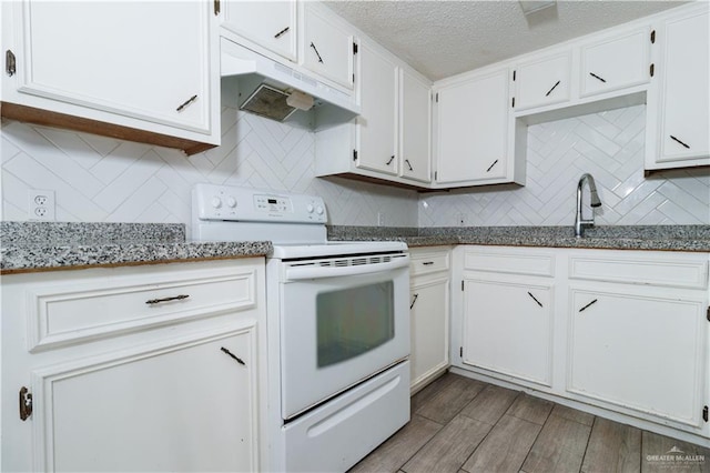 kitchen featuring white cabinets, white electric range, hardwood / wood-style flooring, a textured ceiling, and stone countertops