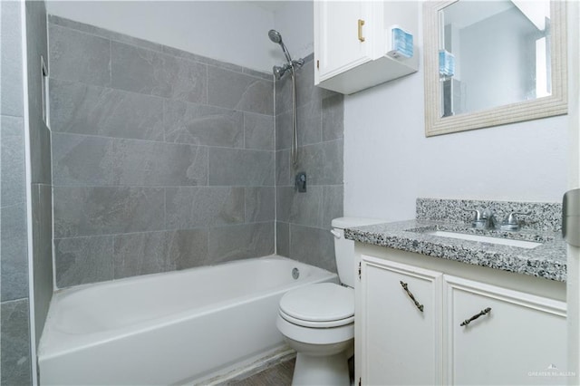 full bathroom with toilet, vanity, and tiled shower / bath