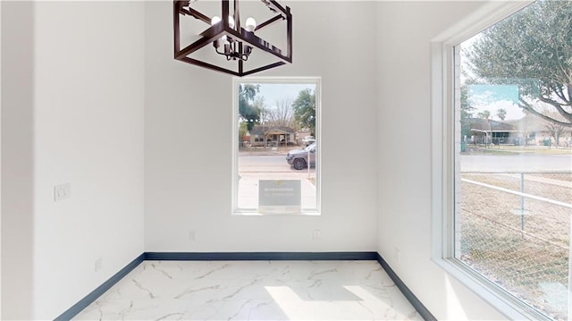 513 E Hawk Ave, Pharr, TX 78577 - unfurnished dining area featuring a chandelier, marble finish floors, and healthy amount of natural light