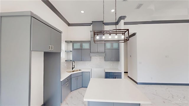 513 E Hawk Ave, Pharr, TX 78577 - kitchen with light marble finish floors, decorative backsplash, gray cabinetry, ornamental molding, and recessed lighting