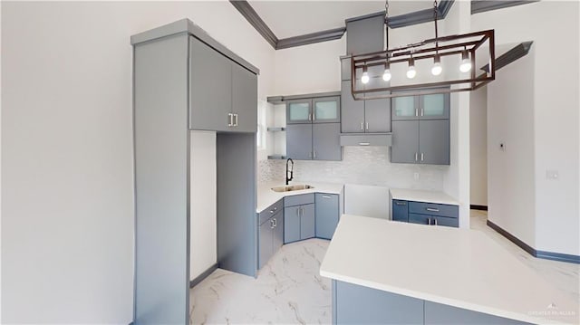 513 E Hawk Ave, Pharr, TX 78577 - kitchen featuring light marble finish flooring, gray cabinets, tasteful backsplash, and crown molding