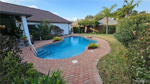 view of pool featuring a patio, a lawn, a fenced backyard, and a fenced in pool