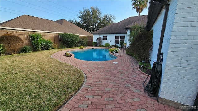 view of pool featuring a patio, a lawn, a fenced backyard, and a fenced in pool