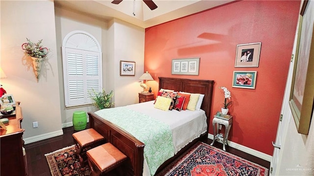 bedroom with dark hardwood / wood-style flooring and ceiling fan