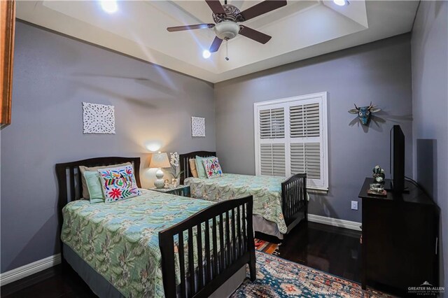 bedroom featuring ceiling fan and dark hardwood / wood-style floors