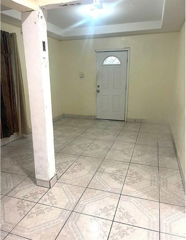 foyer entrance with a tray ceiling