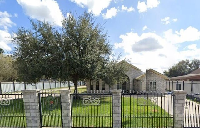 view of gate featuring a yard