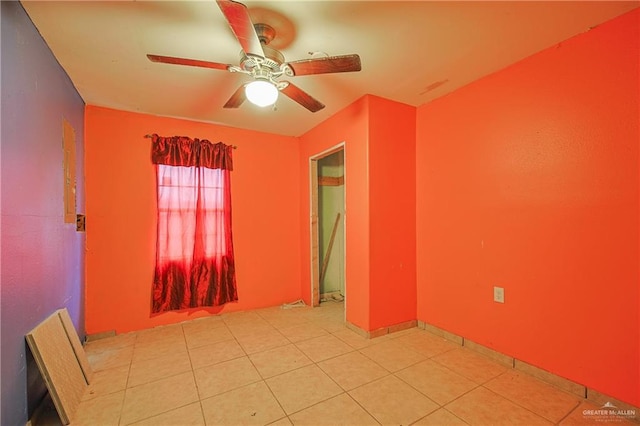 tiled empty room with ceiling fan