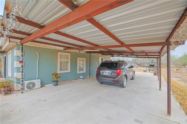 view of parking featuring an attached carport and ac unit