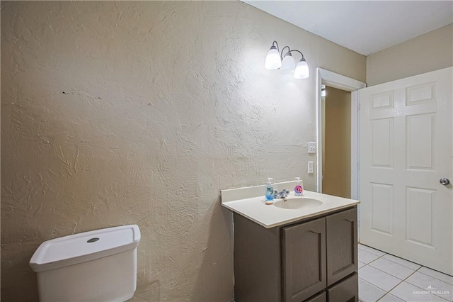 bathroom with tile patterned flooring, vanity, and toilet