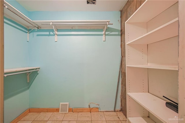 spacious closet with visible vents and light tile patterned flooring