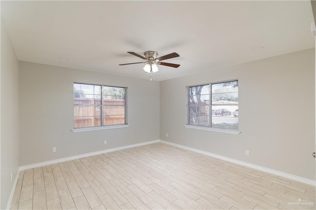 empty room featuring ceiling fan and light wood-type flooring