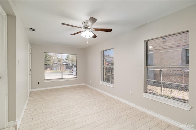 unfurnished room with light wood-type flooring and ceiling fan