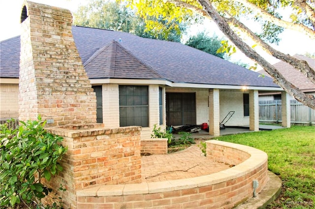 view of front of house with a patio area and a front yard