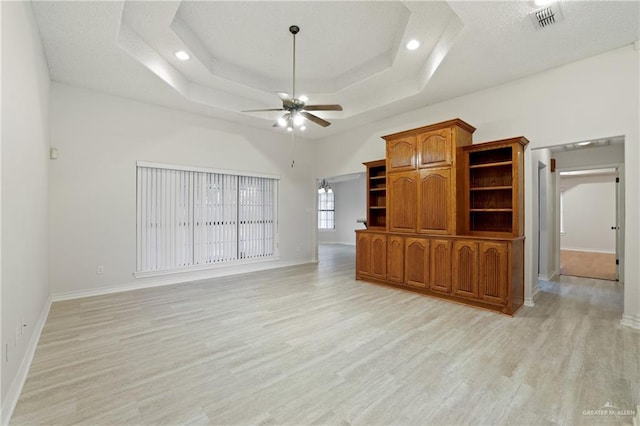 unfurnished living room featuring a ceiling fan, baseboards, visible vents, and light wood-style floors