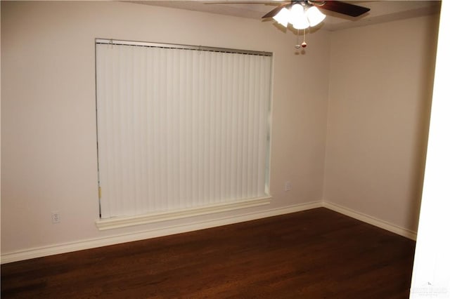 unfurnished room with dark hardwood / wood-style floors and ceiling fan