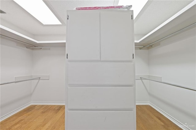 spacious closet featuring light wood-type flooring