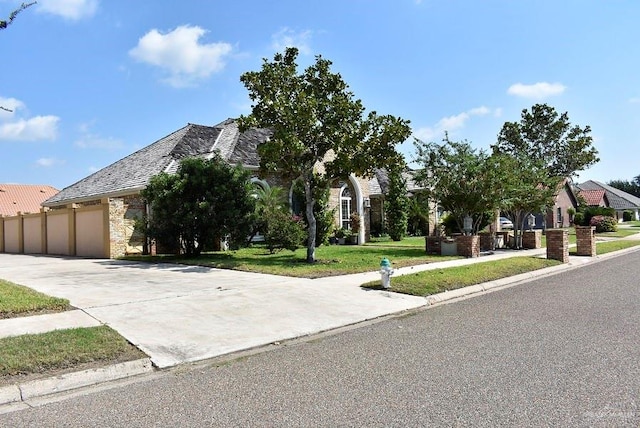 view of front of home with a garage and a front lawn