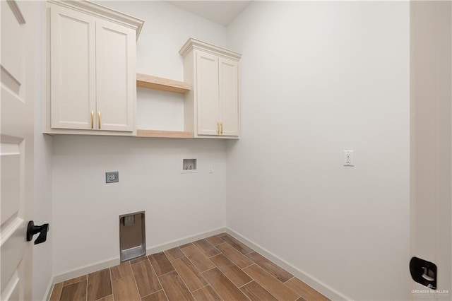 8100 Coyote Dr, Mission, TX 78574 - laundry area with washer hookup, hookup for an electric dryer, wood tiled floors, and cabinet space
