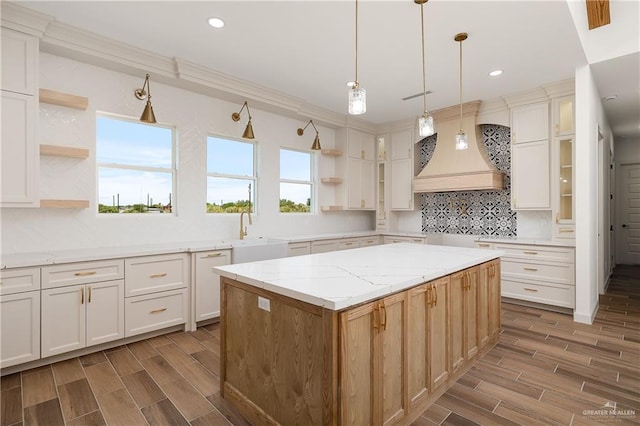 8100 Coyote Dr, Mission, TX 78574 - kitchen with open shelves, custom range hood, decorative backsplash, wood tiled floors, and recessed lighting