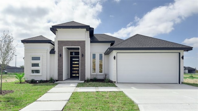 view of front facade featuring a front lawn and a garage