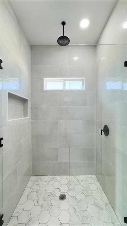 bathroom featuring a shower with shower door