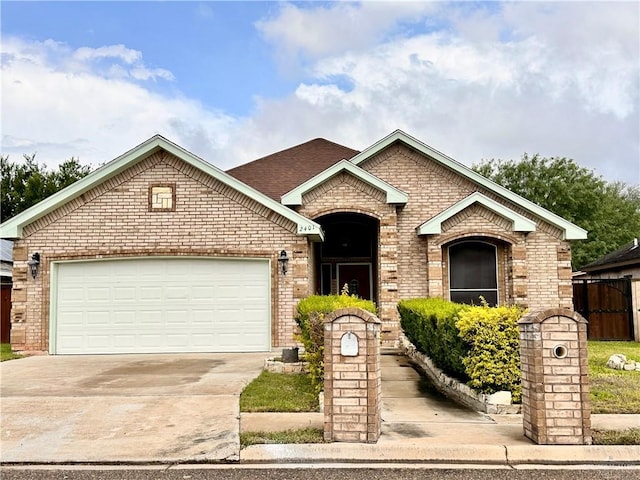 2401 S Gardenia St, Pharr, TX 78577 - view of front of home with brick siding, driveway, and a garage