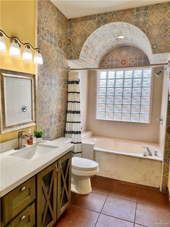 2401 S Gardenia St, Pharr, TX 78577 - bathroom featuring a tub, toilet, tile patterned flooring, vanity, and a shower with shower curtain
