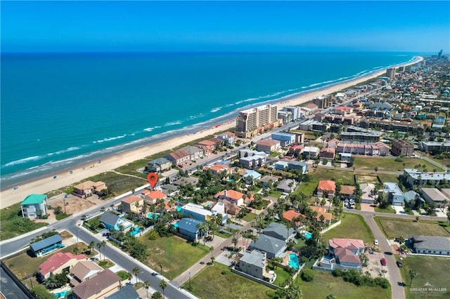 drone / aerial view featuring a water view and a beach view