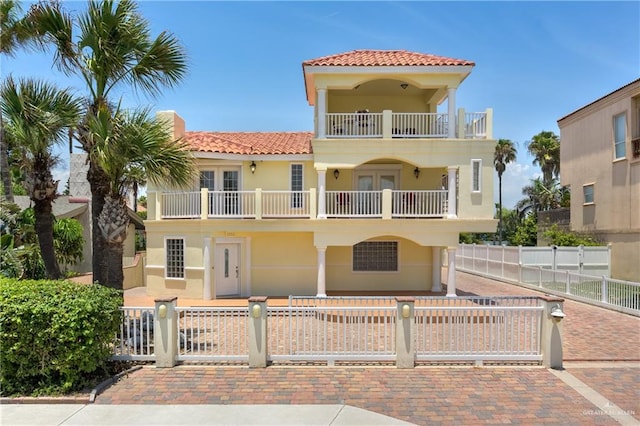 mediterranean / spanish-style house featuring a balcony