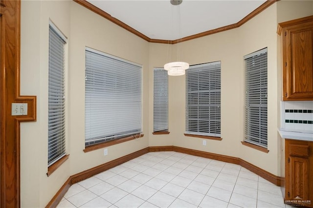 unfurnished dining area featuring a notable chandelier, light tile patterned floors, and crown molding