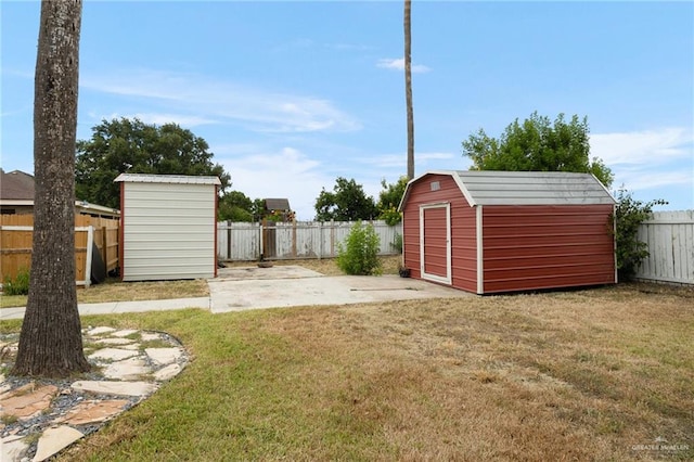 view of yard featuring a patio area and a storage shed