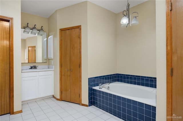 bathroom featuring tile patterned flooring, vanity, a relaxing tiled tub, and a notable chandelier