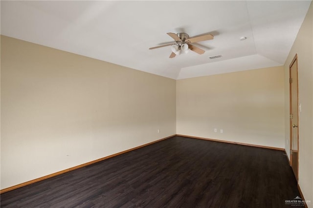 spare room featuring wood-type flooring, vaulted ceiling, and ceiling fan